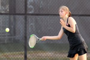 Sophomore Zoe Gutz reaches for the ball to hit back to her opponent. Gutz played a tough singles match but ultimately lost. 