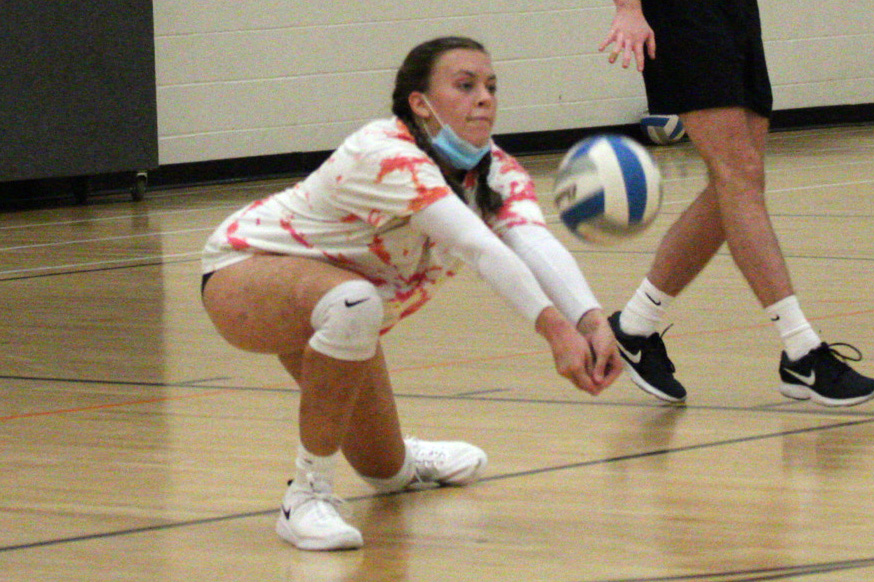 Senior Macy Martinson protects the ball from the ground at practice Oct 7.  The first varsity volleyball game of the season is at 9 a.m. Oct. 10 at the Benilde-St. Margaret’s Activity Center against Benilde-St. Margaret.
