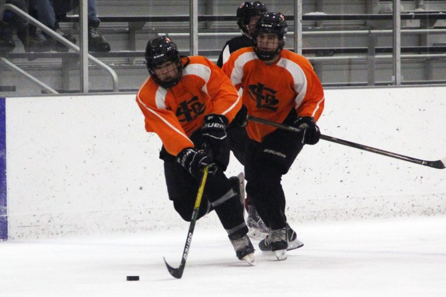 Senior Austin Amelse maintains control of the puck as he skates up the ice toward Osseo’s goal. Park lost 9-3 to Osseo.