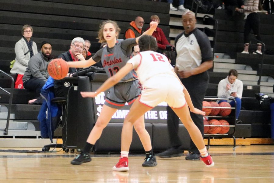 Senior Sadie Yarosh looks for a teammate to pass the ball to. The girls basketball season got postponed due to COVID-19.