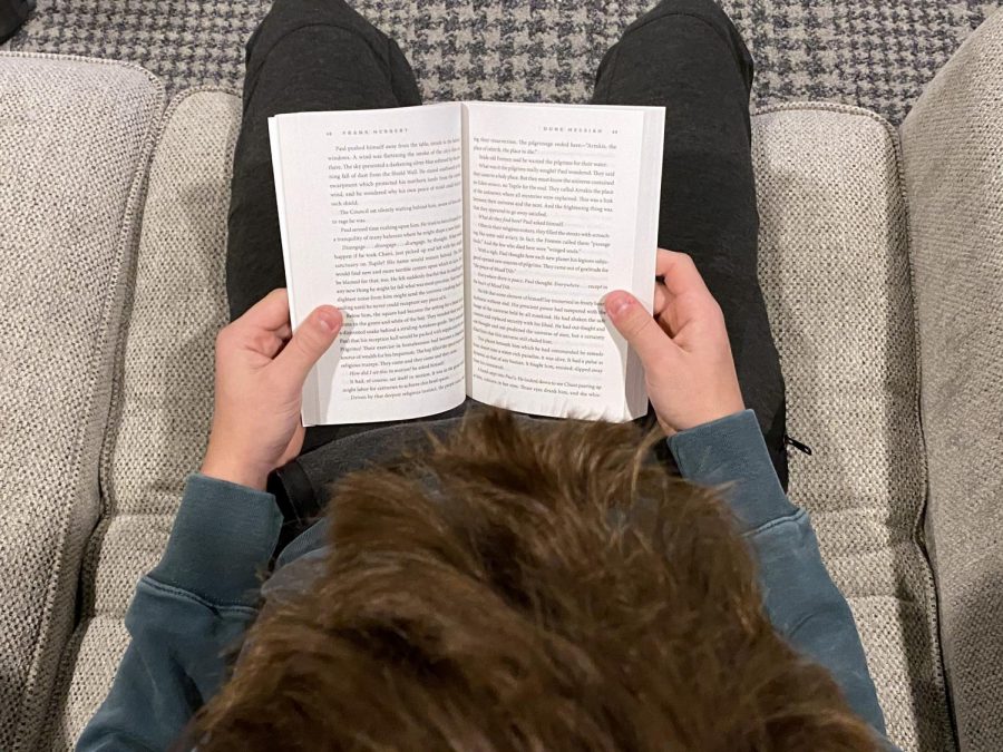 Photo illustration by Oliver Smith. Freshman Wesley Smith reads “Dune” by Frank Herbert. Smith has picked up reading as a hobby to pass time in doors.
