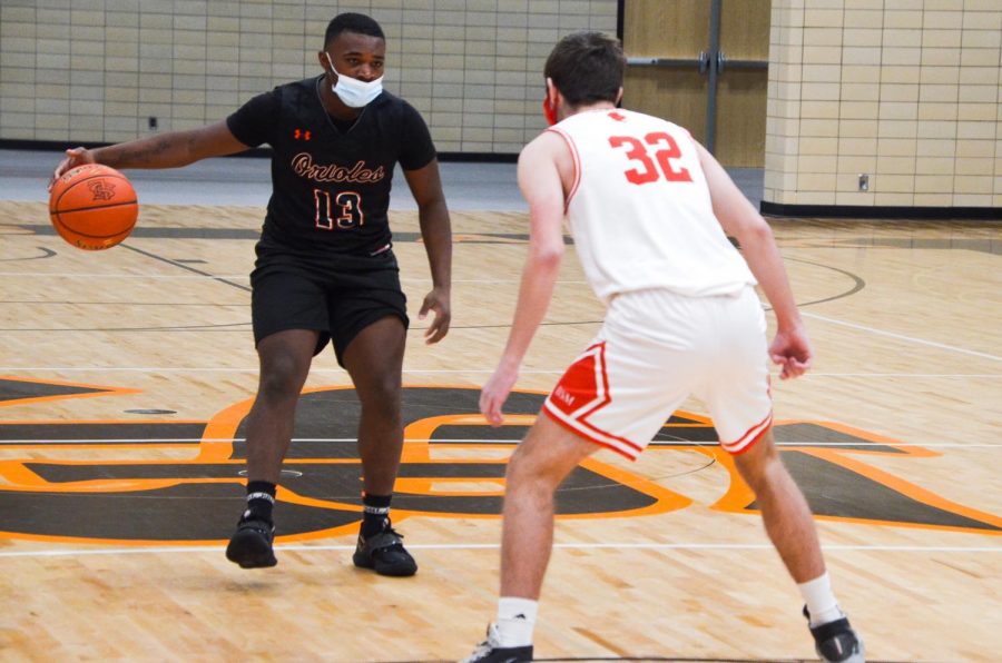 Senior Jordan Moore dribbles down the court in a game against Benilde Feb. 5. Athletes struggling in classes will now be required to attend tutoring on Wednesdays.
