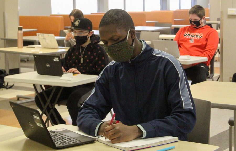 A student works in the cafeteria Feb. 25. Superintendent Astien Osei will presenting a potential start date to hybrid to the School Board March 8.  