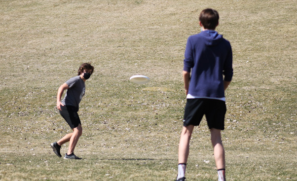 Freshmen Tommy Walsh and Thomas Shope throw a frisbee around at Minikahda Vista park April 3. Spring sports are in full session as of April 5.