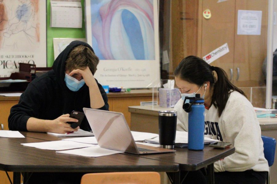 Seniors Emma Amon and Jack Fredrickson work during english class April 19. Many students were involved in the interview process for the new principal.