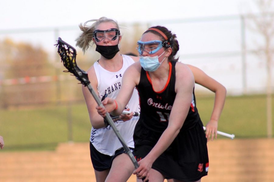 Senior Claire Bargman catches the ball April 30. Girls lacrosse lost to Chanhassen 17-0.