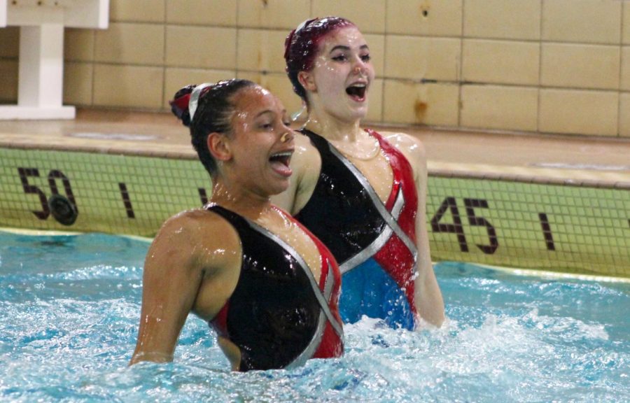 Seniors Bella Steward and Maya Lee pop out of the water during a dress rehearsal May 18. The synchronized swimming team competed in sections May 22.