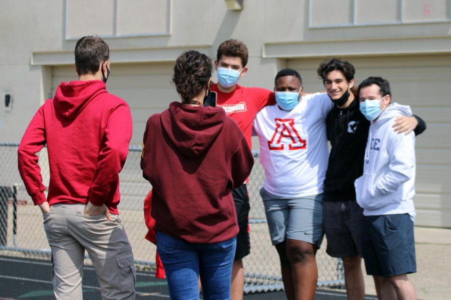 Business teacher Sophia Ross takes a photo of senior Jonah Smith, Michael Boxley, Adin Zweigbaum and Daniel Goldenberg May 3. Students were encouraged to wear masks during the gathering.
