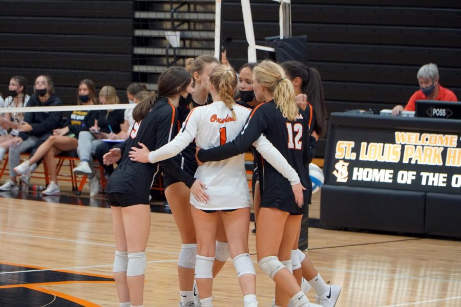 The girls volleyball team comes together after scoring a point Sept. 9. Park lost to Waconia 3-0.