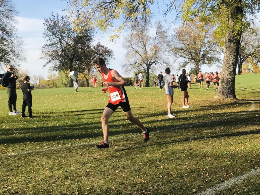 Freshman Casey Howard rounds a corner in the boys' varsity 5,000 meter race. His team finished in 8th place at the Metro West Conference Championships.