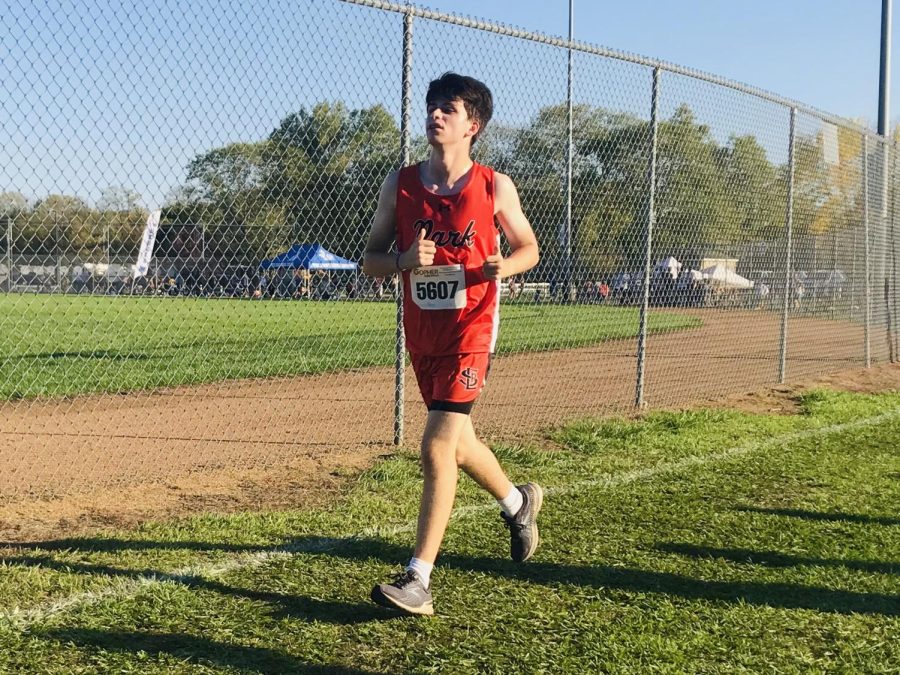 Freshman Caleb Teichman pushes past his limits in the boys JV 5,000 meter race. His team finished in 12th place.