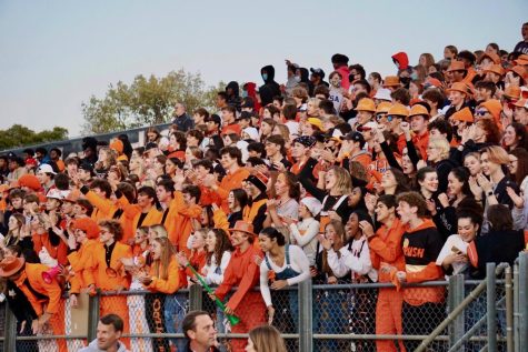 Student section cheers after a touchdown while wearing the all-orange dress code Sept. 24. Park won its homecoming game against crosstown rival Benilde St. Margaret.