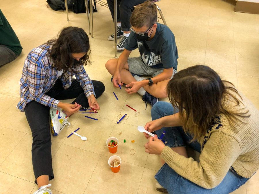 Senior Ella Runyan works with her team to build a gummy bear tower at German Clubs meeting Oct. 6. Contests also include a gummy bear race, catapults and trivia