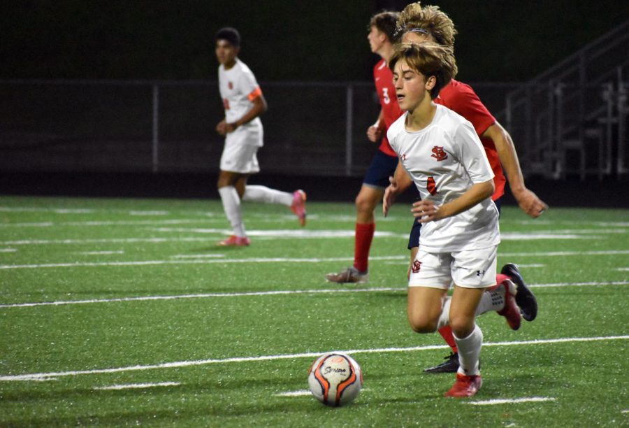 Freshman Elijah Proost passes the ball to a teammate Oct. 5. Proost has scored three goals this season.