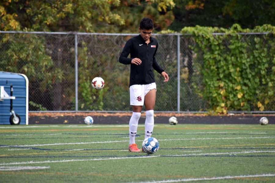 Senior Bennett Kouame warms up before a game Oct. 9. Kouame was one of three seniors to win the All-State award.