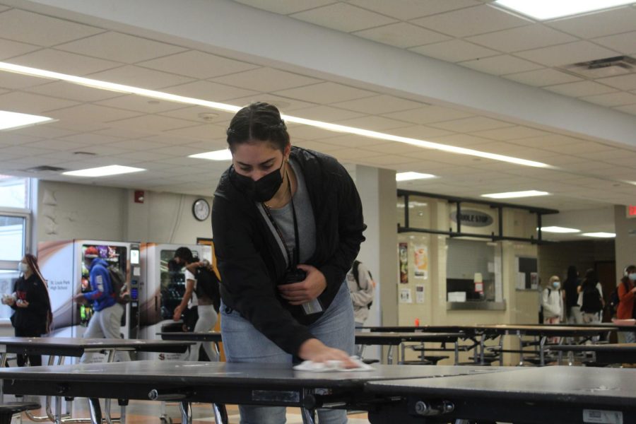 Kaelyn Dagon wipes down cafeteria tables Nov. 15. Dagon is the newest Achievement Support Coordinator at Park. 
