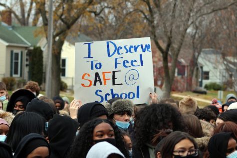 Students hold up sign in support of a safe community. Walkout was held from 6th hour until the end of the school day.