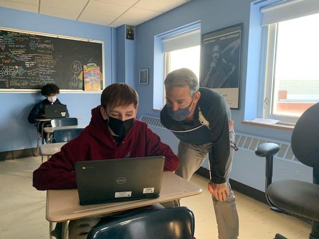History teacher Jeffrey Cohen assists student Ford Marciniak in filling out forms for student-led conferences. Student facilitated conferences will be held the week of Nov. 15. 