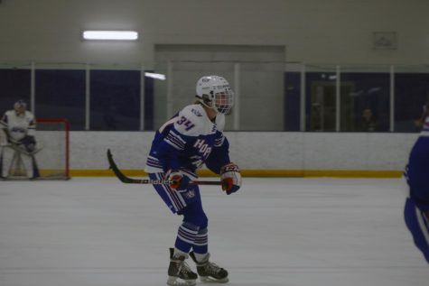 Sophomore Camry Witham prepares to steal the puck from Holy Angels Nov. 30. Hopkins-Park lost 3-1. 