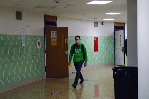 Senior Paris Lim walks down the hall after school Nov. 3. Students will be asked to leave the building after 3:30.