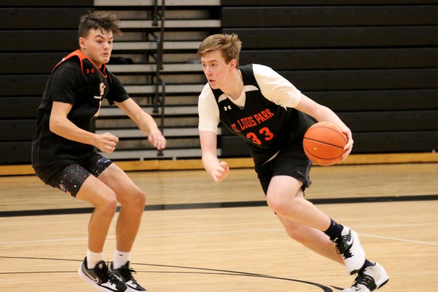 Senior+Blake+Anderson+drives+to+the+net+looking+to+make+a+basket.+Athletes+are+not+required+to+wear+masks+during+practices+and+games%2C+but+they+are+recommended+by+the+athletic+department+and+MSHSL.
