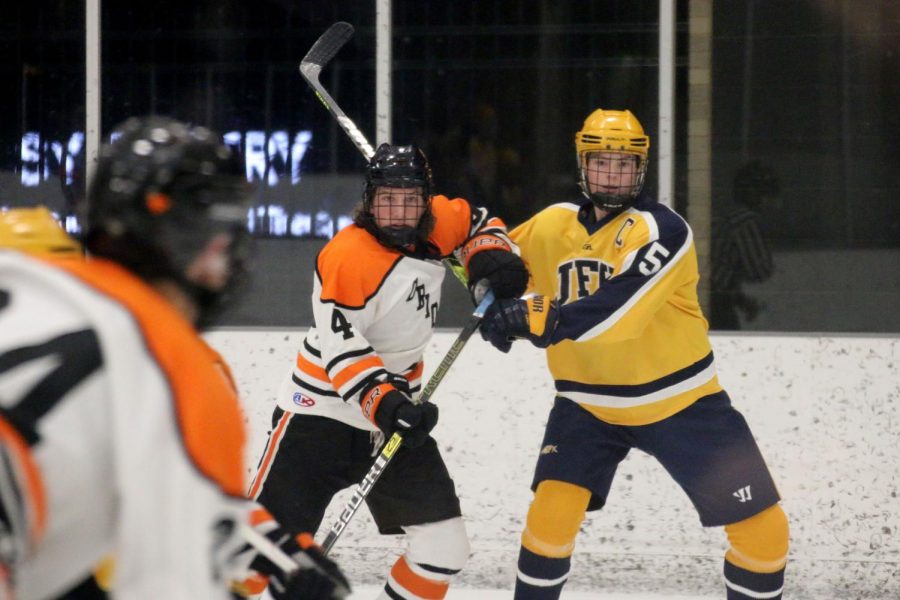 Sophomore Griffin Krone pushes opponent to defend the puck. Park won against Kennedy 6-1.
