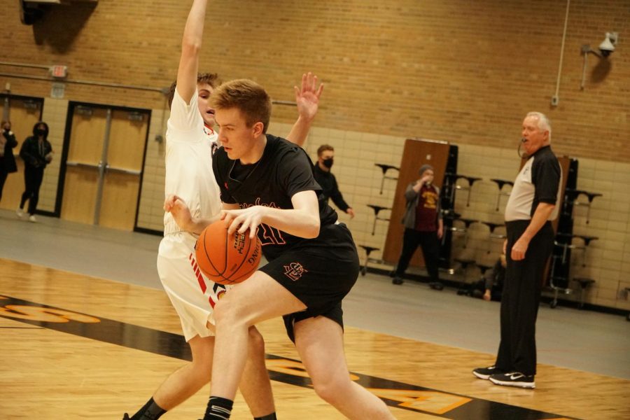 Senior Blake Anderson drives to the hoop to score the game winning basket against Orono Jan. 11. Anderson blocked a layup by Orono on the next play to clinch the win.