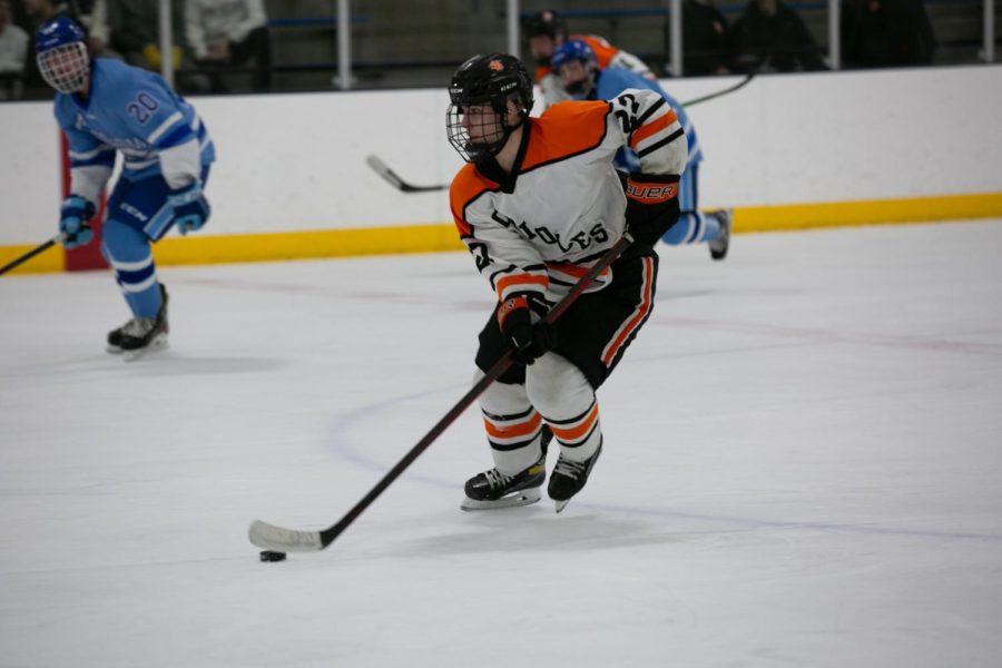 Junior Cole Taylor travels with the puck Jan 11. Taylor is apart of the teams defense.