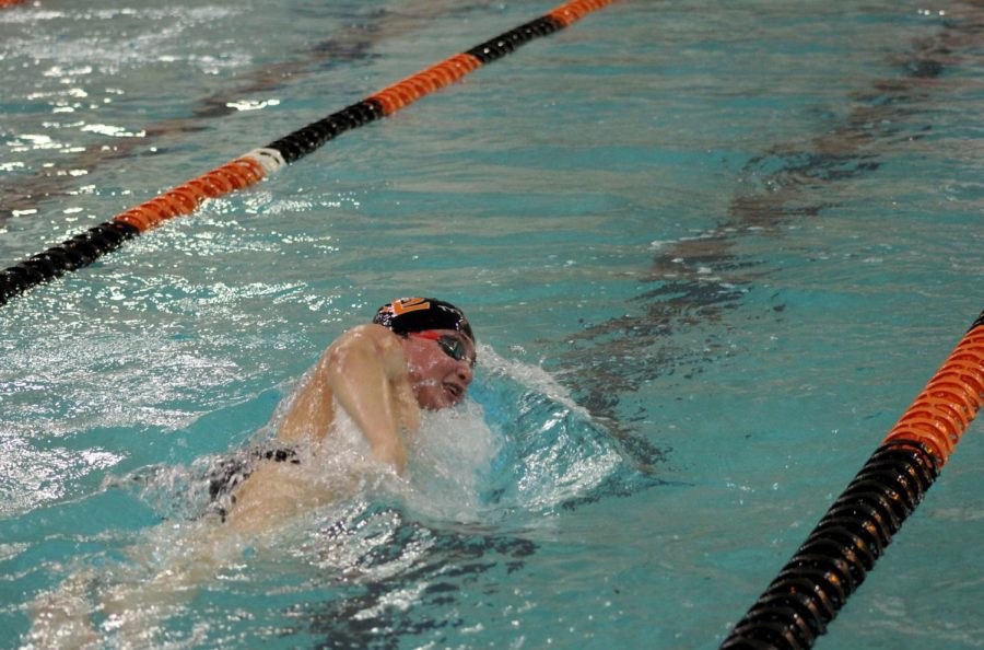 Senior captain Andre Barajas swims the 500-freestyle. Seniors were supported by families at the meet.