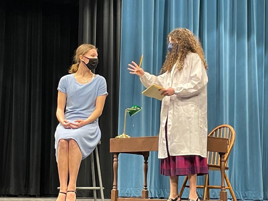 Senior Louise Marshall and junior Emma Samuels rehearse a pivotal scene Feb. 3. In the show, Catherine Donahue goes to the company doctor to receive medical aid, following radium poisoning.