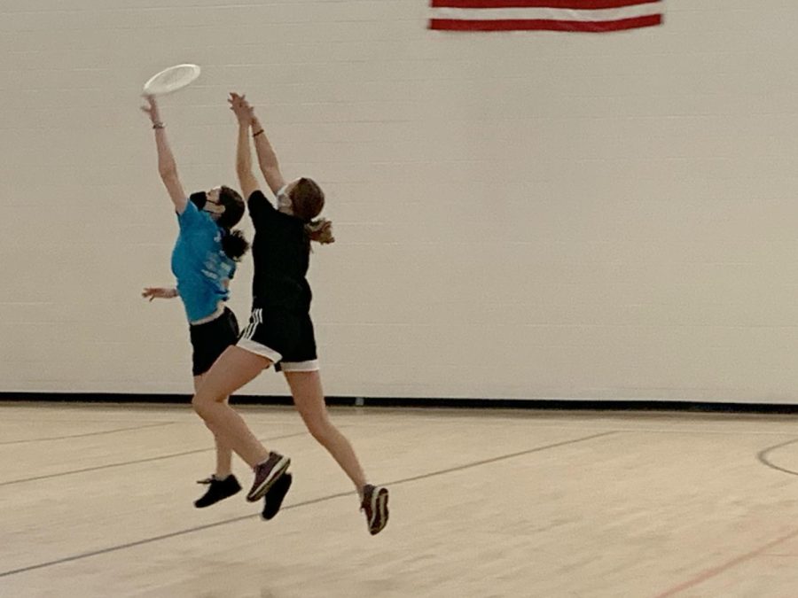 Juniors Isabel Nathan and Greta Runyon compete for who can get the disc Feb. 19. Girls Ultimates next practice will be held March 2.