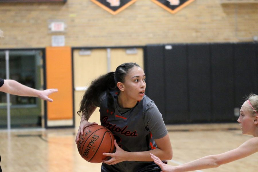 Senior Selam Maher looks to pass the ball Feb. 11. Maher is committed to play womens collegiate basketball for Smith College.