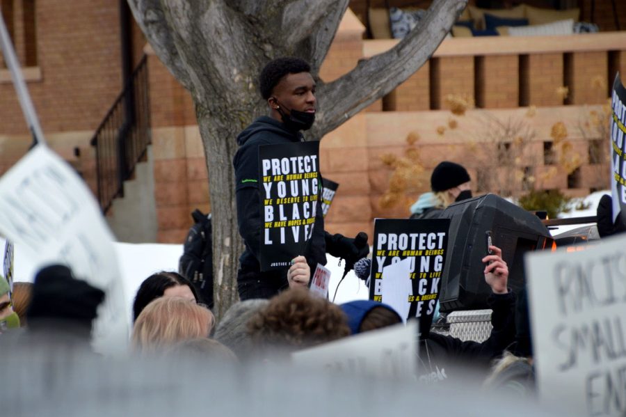Senior Ezra Hudson holds a sign while students gather outside St. Paul Central Feb. 8. Hudson, a co-founder of MNTeenActivists, helped lead the protest.