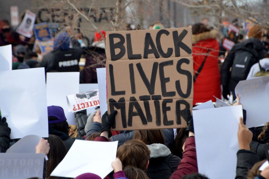 A student holds up a Black Lives Matter sign Feb. 8. Many students prepared signs before to bring to the protest.