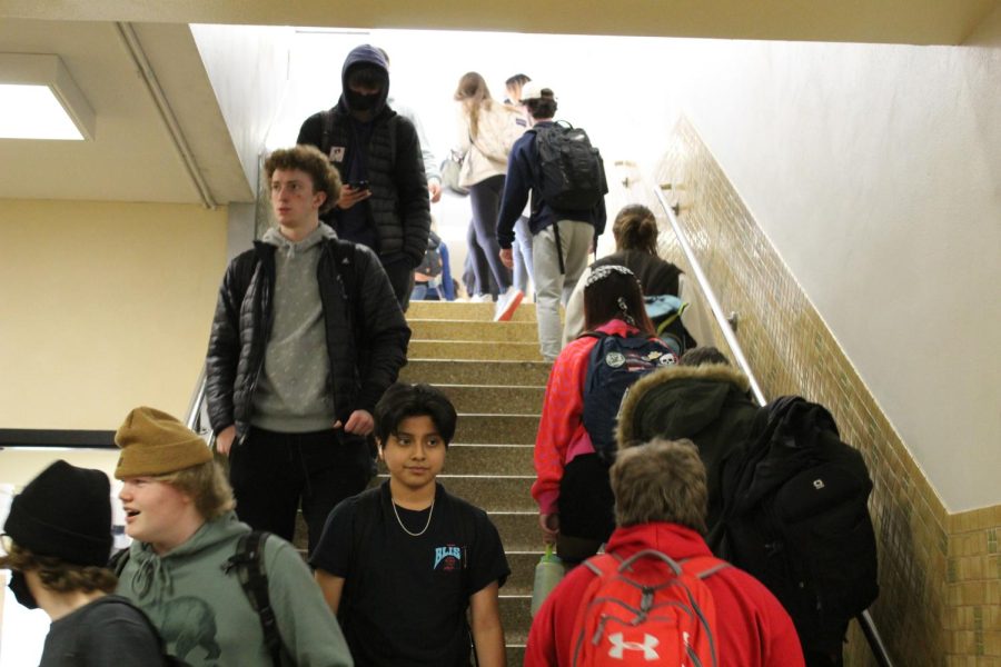 Stefano Giovannelli walks down the stairs March 10. On March 9, the School Board accepted a revision to policy 808, causing masking at schools to be optional.