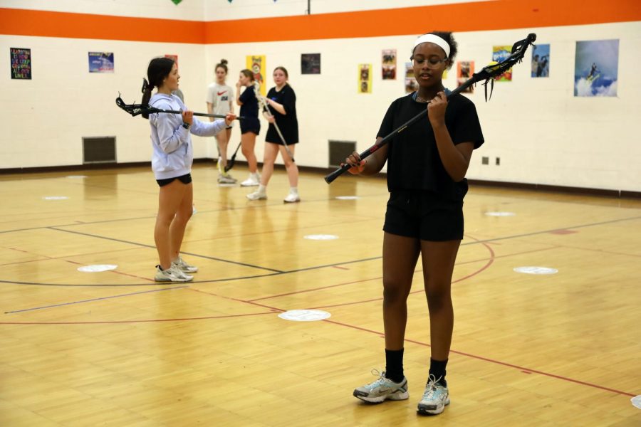 Sophomore Margaux Pollock and Freshman Tarike Meyerhoff  practice side arm throws March 21. This was the final captains practice for the girls lacrosse team.