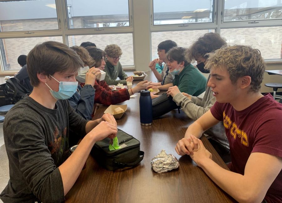 Sophomores+eat+lunch+together+without+facing+a+mask+mandate+barrier+March+17.+Many+students+still+choose+to+wear+masks+although+it+is+not+mandatory.