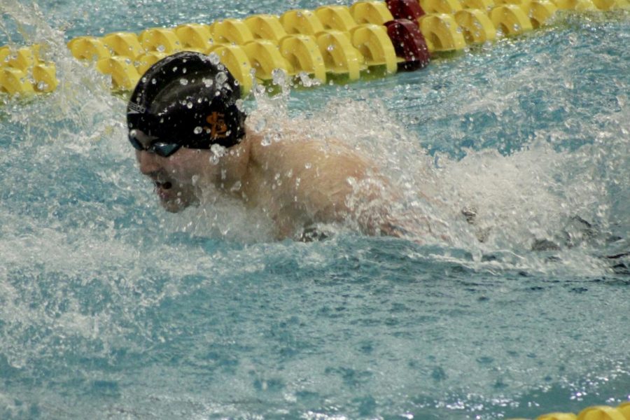 Senior Hiro McKee swims the 100 yard fly March 4. McKee placed 16th in preliminaries, qualifying for the state championship. 