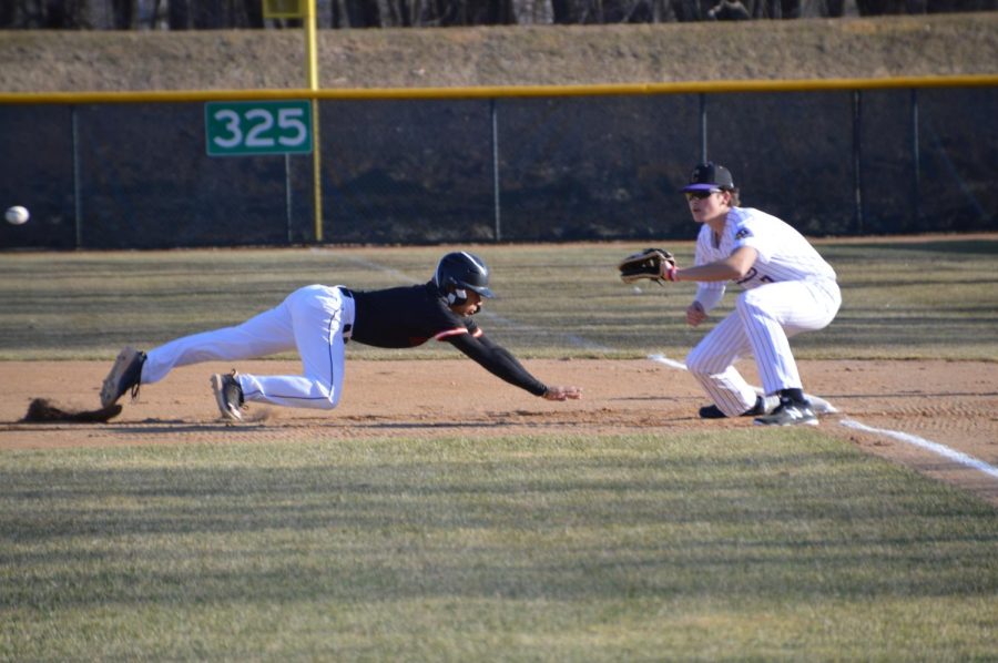 Senior Stanley Regguinti dives back to the base to avoid being picked off against Chaska April 11. Regguinti was one of the few Park players to get on base throughout the game.
