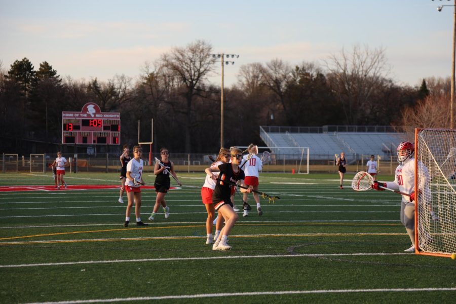 Eighth+grader+Riley+Ridgway+scans+the+net+as+she+prepares+to+shoot+during+the+first+half+of+the+game+April+21.+Girls+lacrosse+lost+17-1+in+its+first+game+of+the+season.