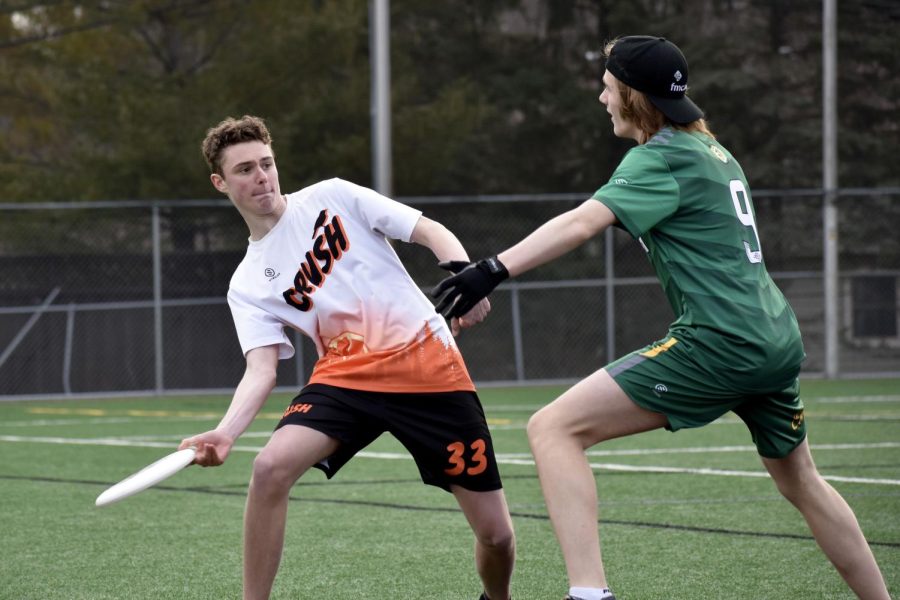 Junior Josh Madigan throws the frisbee to a teammate April 10. JV Ultimate finished their first tournament with a record of 2-1.