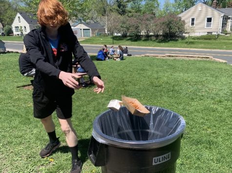 Sophomore Silas Cowell disposes a lunch tray May 16. Trash cans are available throughout the school and outside for students to use.