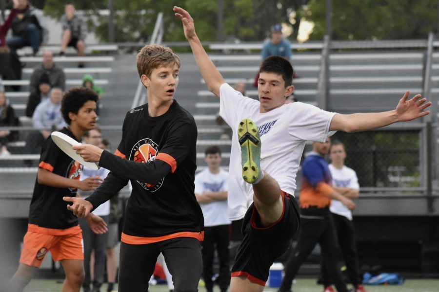 Senior Joe Mcgurgan goes to throw the disc while an Andover defender attempts to block the pass May 26. Crush will attend Nationals June 10 and 11.