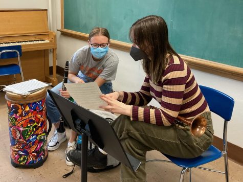 In a practice room, junior Greta Runyon and Gretchen Huebsch study sheet music May 9. In order to keep up with an IB course-load, the Independent Study Wind Ensemble allows students to practice band on their own time.