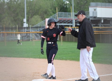 Junior captain Kamryn Halley celebrates a successful at-bat with assistant coach Al Wachutka. Park lost 1-10 against Benilde St. Margarets May 20. 