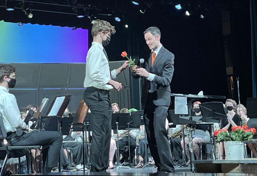 Onstage%2C+senior+Carlitos+Anguita-Smith+receives+a+rose+from+Band+Director+Steve+Shmitz+May+3.+After+the+band+concert%2C+Shmitz+handed+out+roses+to+recognize+the+achievements+of+the+graduating+seniors.