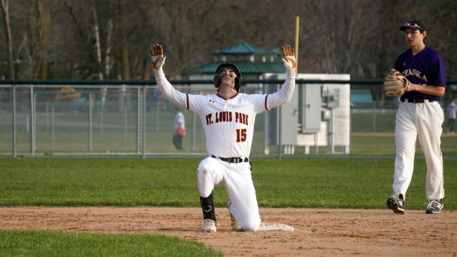Senior Kristofer Hokenson kneels at second base to celebrate his hit to center field May 4. Hokenson will be continuing his baseball career at the University of Minnesota as a pitcher and outfielder.