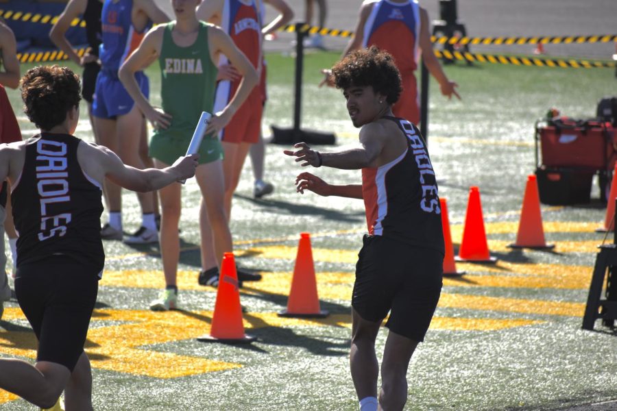 Senior Bennett Kuoame reaches for the baton June 2. Park participated in the Section finals at Wayzata High School. 