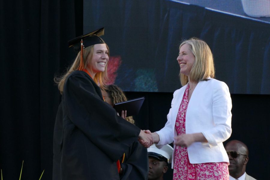Onstage, senior Erin Kozlowski receives her diploma June 7. Members of the school board were in charge of handing out diplomas. 
