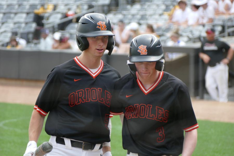 Junior Stefano Giovannelli talks with senior Ben Farley after hitting the ball out of the field June 14. The tournament was held at CHS field. 